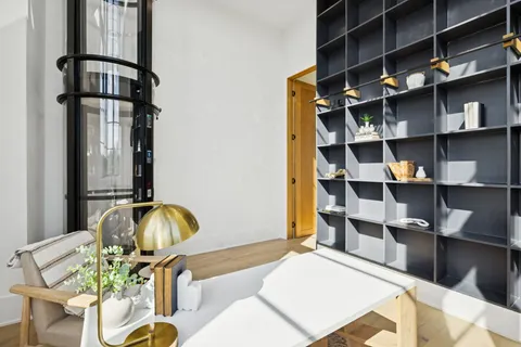 a living room with furniture and a floor to ceiling window