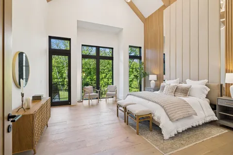 an empty room with a window and a ceiling fan