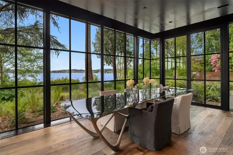 a view of a living room with furniture and floor to ceiling window