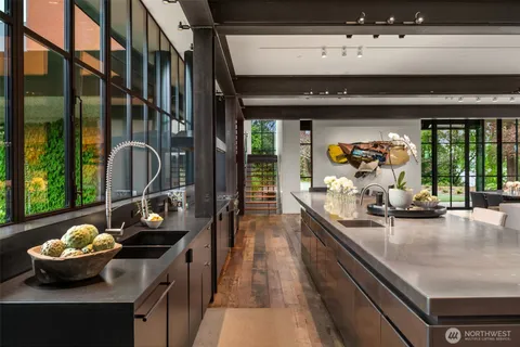 a dining hall with stainless steel appliances granite countertop a granite counter tops and a large window