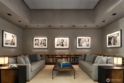 a living room with furniture a floor to ceiling window and a flat screen tv