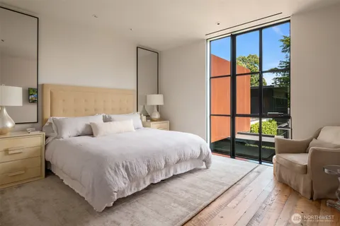 a living room with furniture a rug and a large window