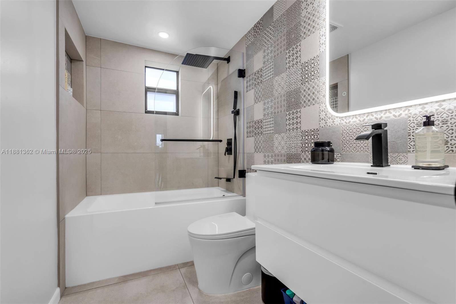 1642 Southwest 16th Street Miami, FL 33145 - Photo 14 of 28 a bathroom with a toilet a sink and a bathtub