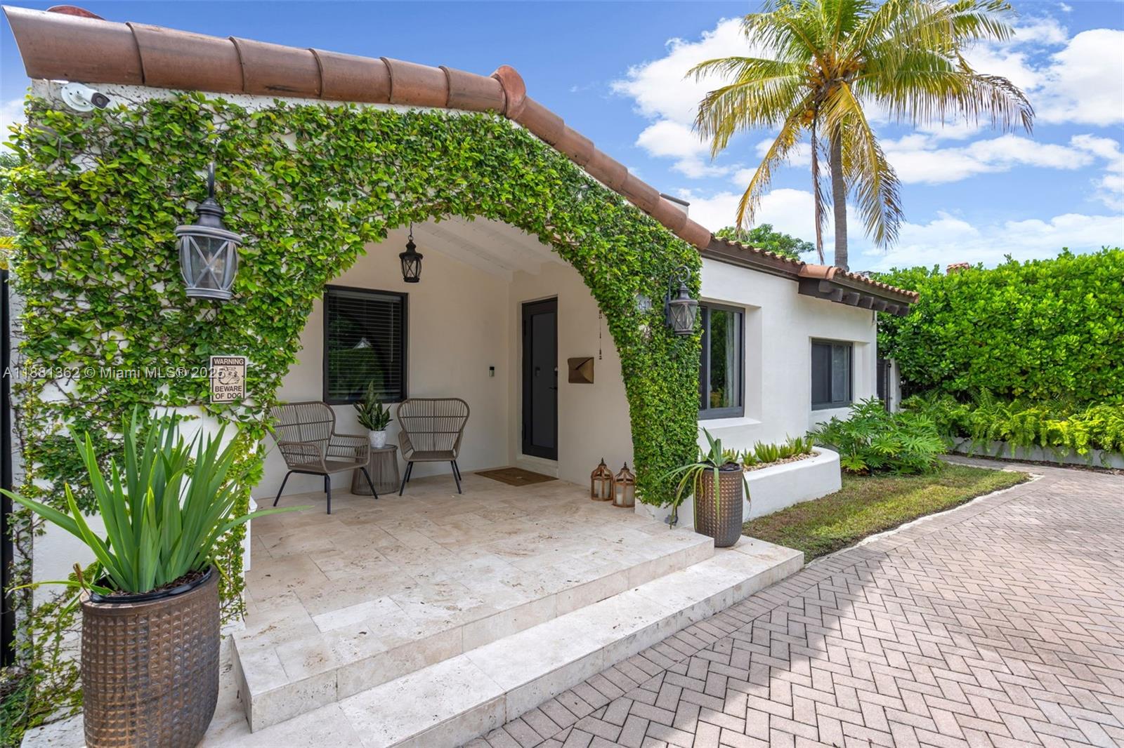 1642 Southwest 16th Street Miami, FL 33145 - Photo 23 of 28 a view of a patio with table and chairs potted plants and palm trees