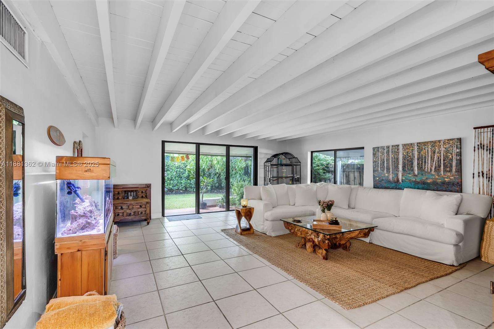 1642 Southwest 16th Street Miami, FL 33145 - Photo 8 of 28 a living room with furniture and a floor to ceiling window