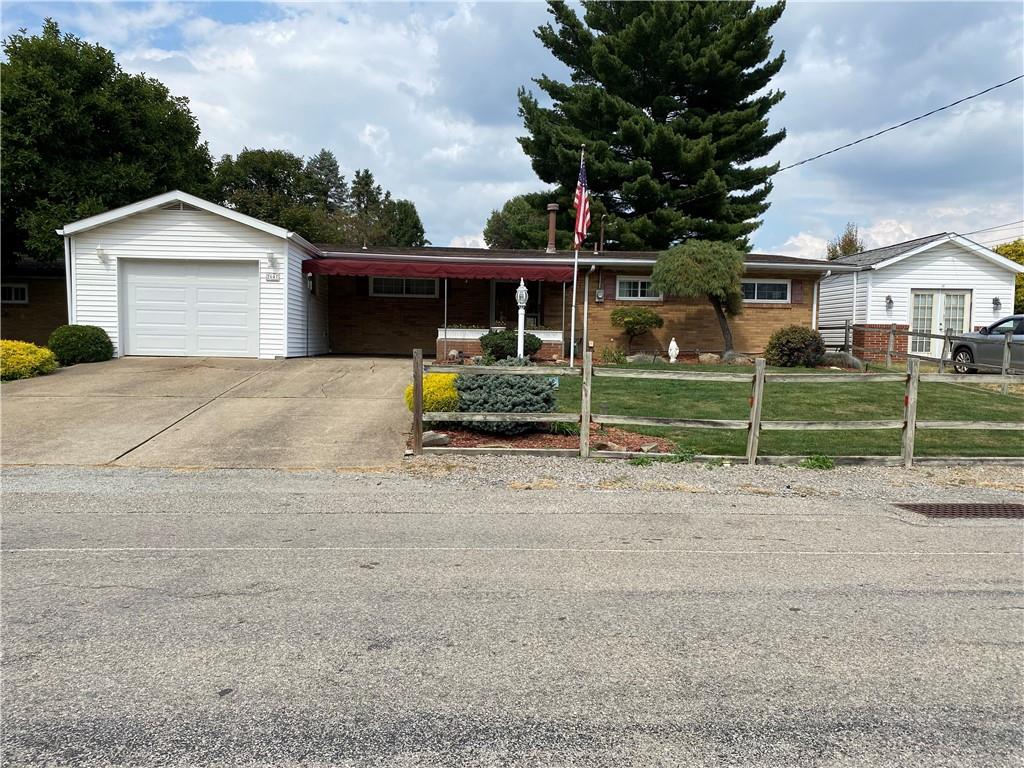 a view of a house with a backyard and a garage