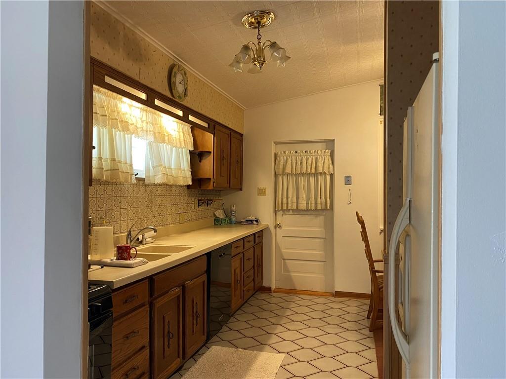 2647 Paige Street Lower Burrell, PA 15068 - Photo 3 of 13 a bathroom with a sink a mirror and a shower