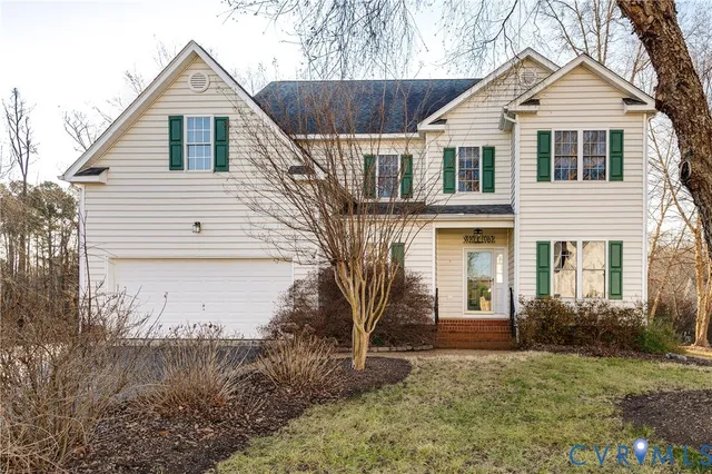 a view of a yard in front of a house with large trees
