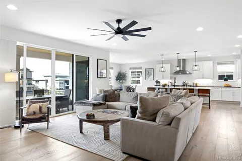 a living room with furniture and kitchen view