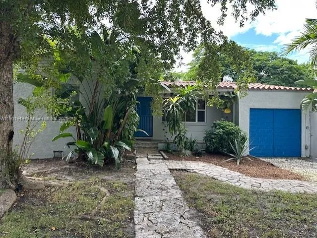 a view of a house with a tree