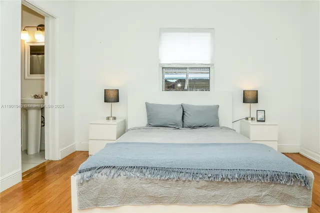 a spacious bedroom with a bed and a window