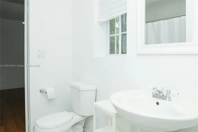 a white toilet sitting next to a bathroom sink
