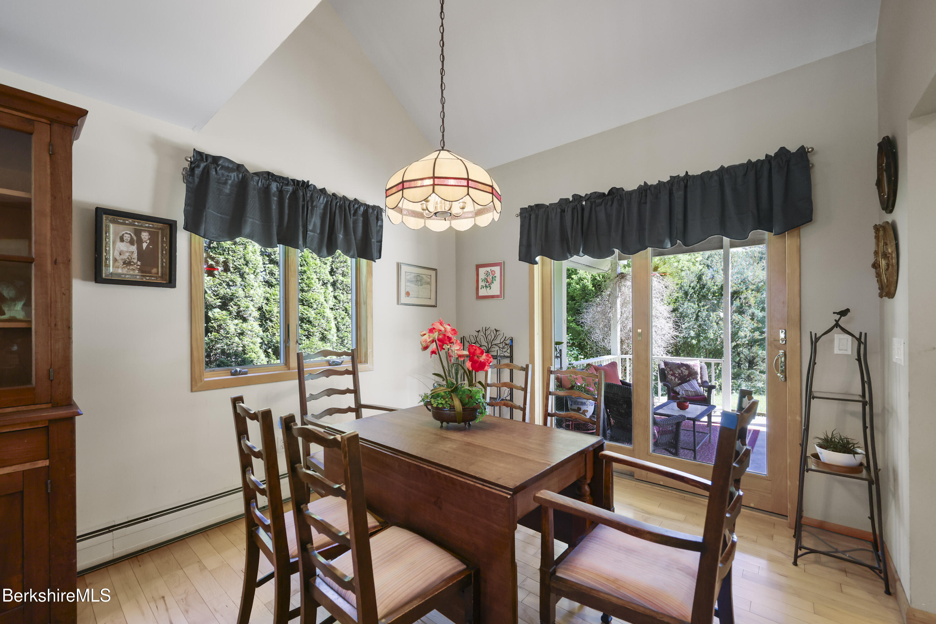 83 Hancock Road Pittsfield, MA 01201 - Photo 11 of 51 a view of a dining room with furniture a chandelier and wooden floor