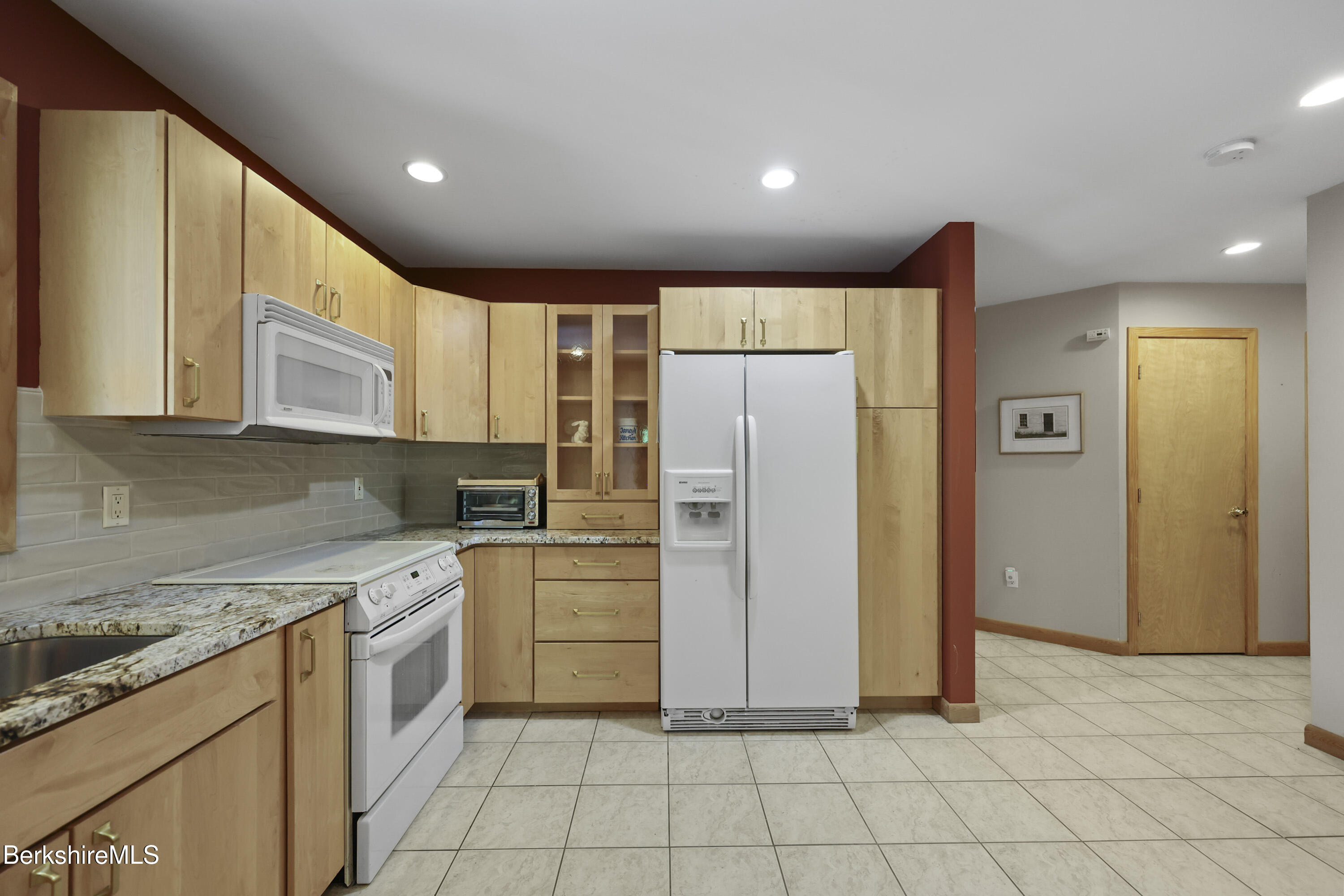 83 Hancock Road Pittsfield, MA 01201 - Photo 15 of 51 a kitchen with a refrigerator sink and cabinets