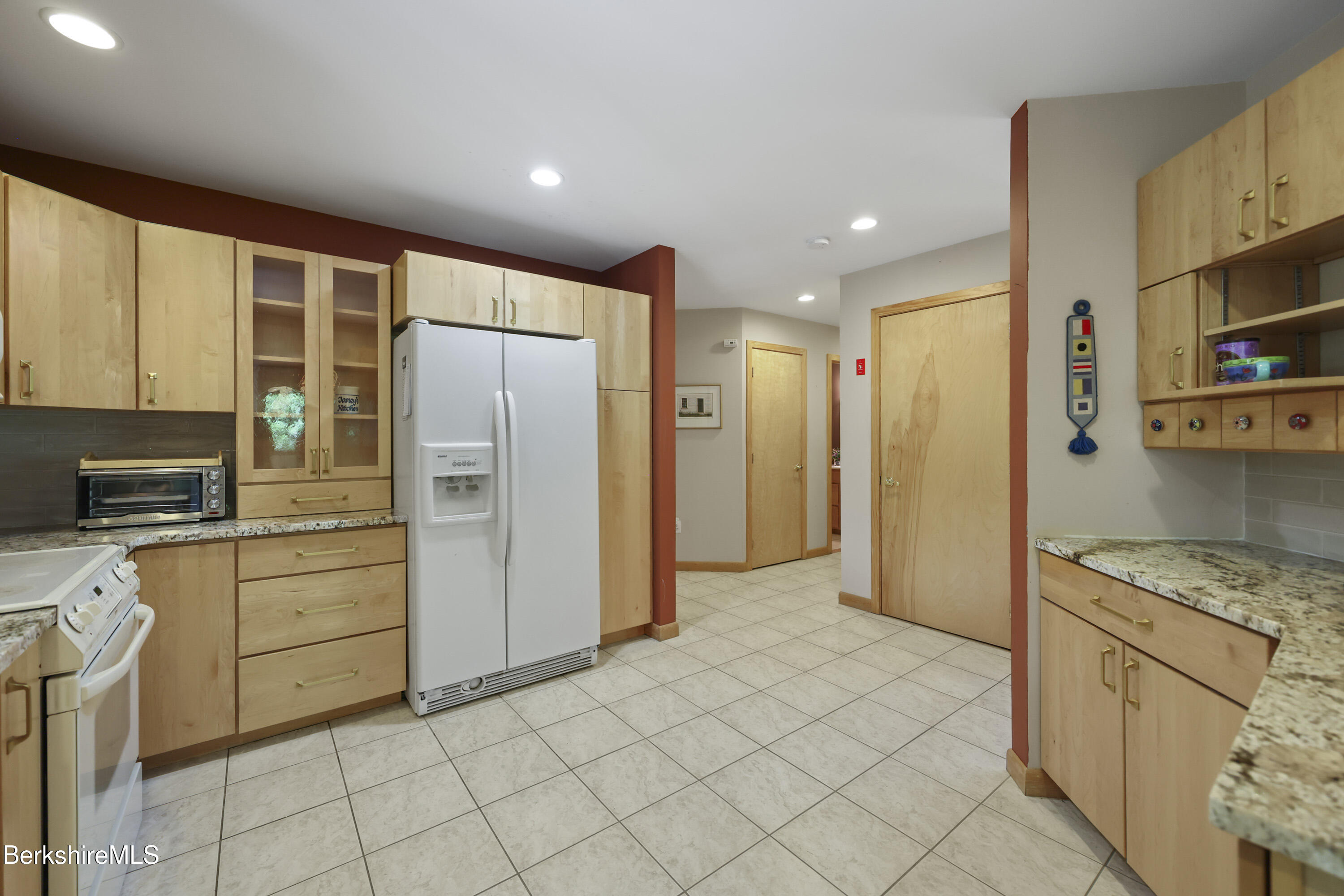 83 Hancock Road Pittsfield, MA 01201 - Photo 17 of 51 a kitchen with stainless steel appliances granite countertop a refrigerator and a stove top oven
