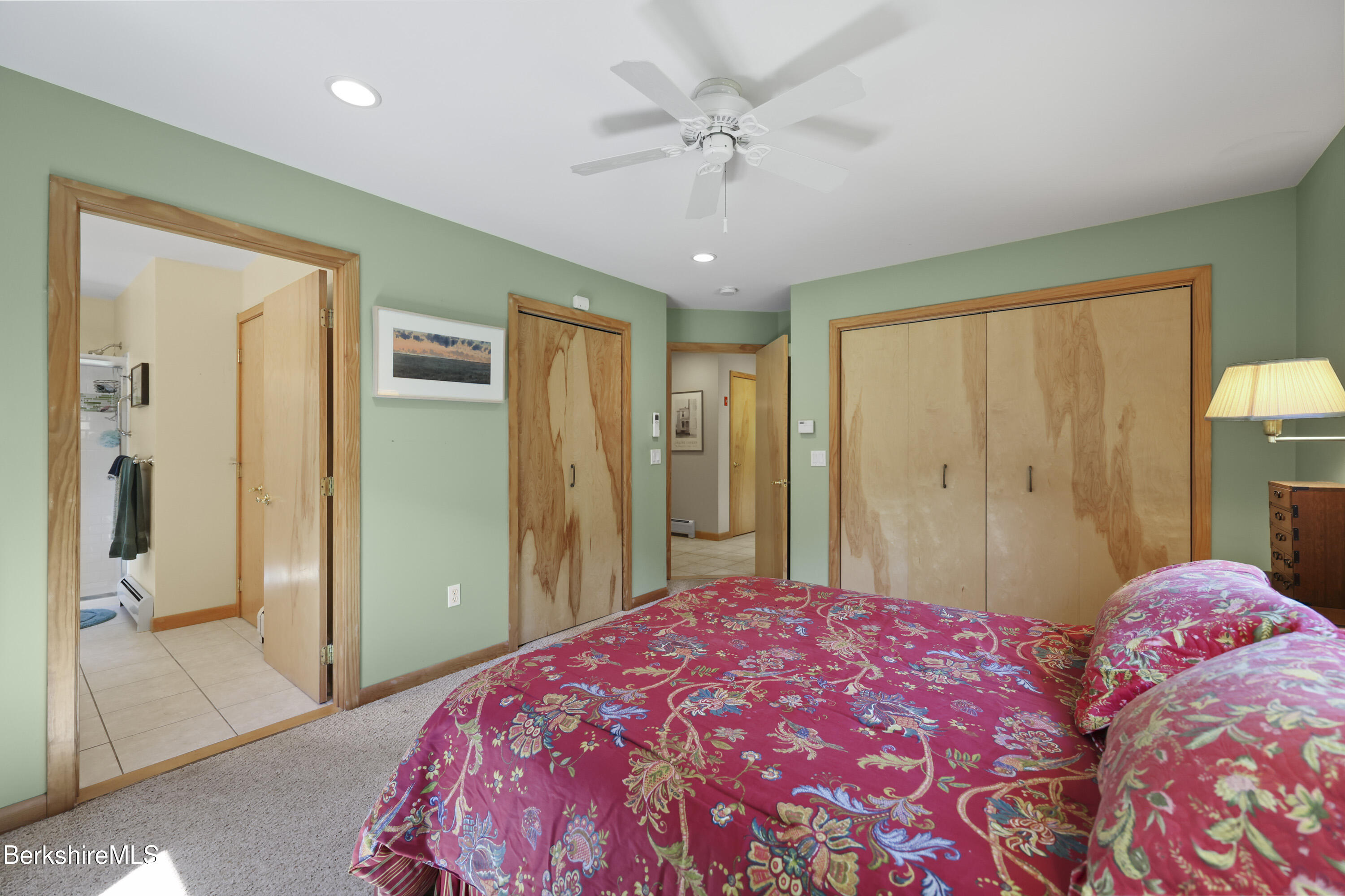 83 Hancock Road Pittsfield, MA 01201 - Photo 21 of 51 a bedroom with a large bed and a chandelier