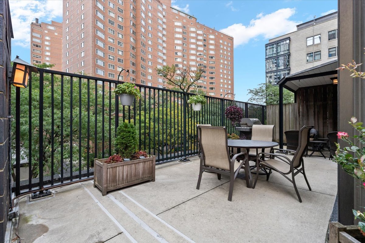 1310 North Ritchie Court, Unit 3A Chicago, IL 60610 - Photo 15 of 23 a view of a patio with a table and chairs and potted plants