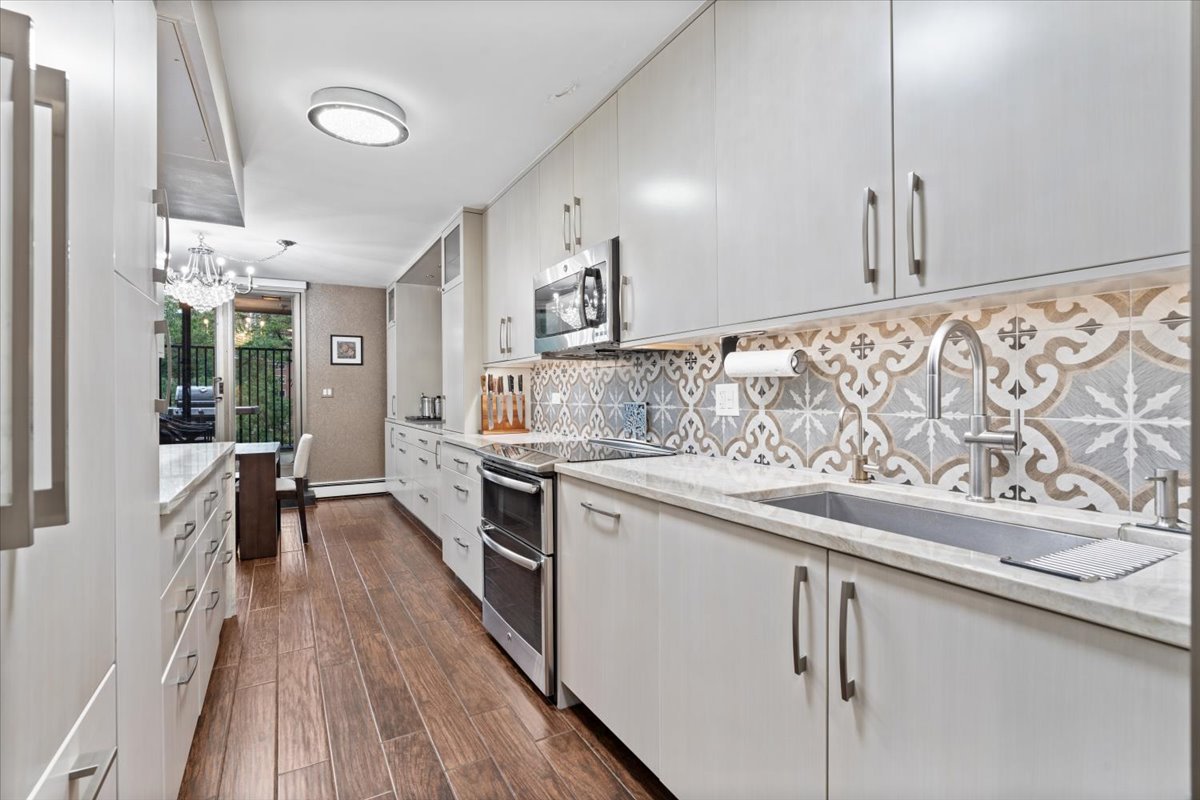 1310 North Ritchie Court, Unit 3A Chicago, IL 60610 - Photo 4 of 23 a kitchen with stainless steel appliances granite countertop a stove a sink and a refrigerator