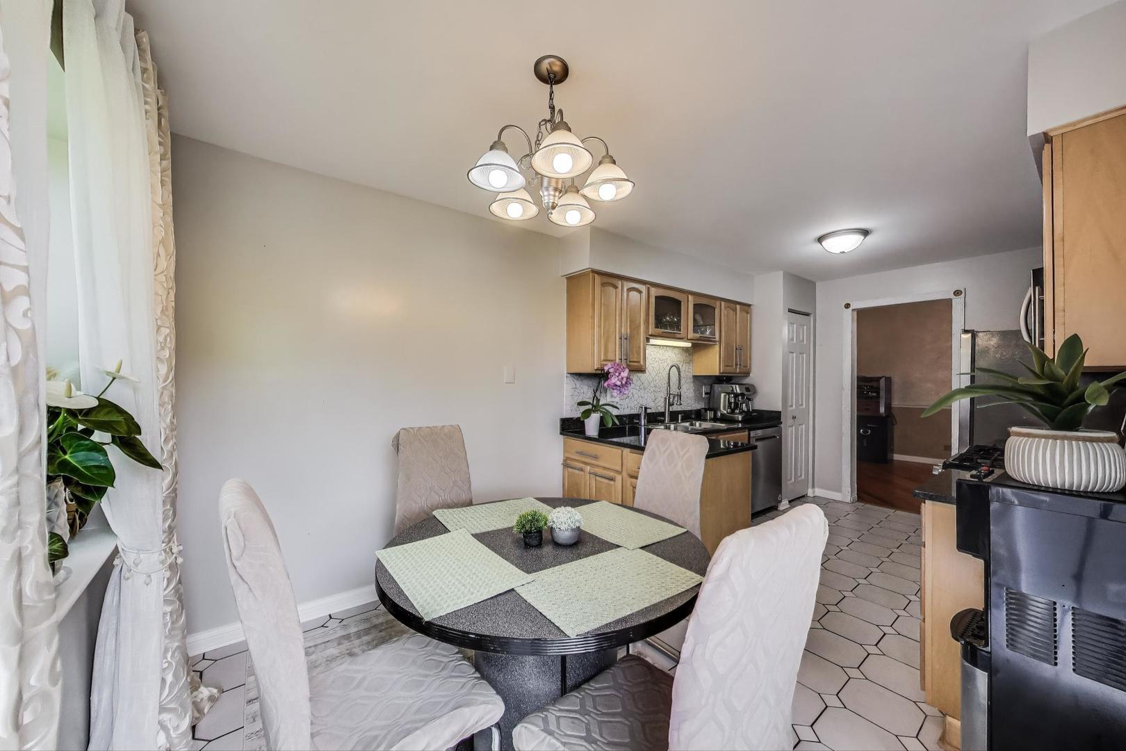 738 Hapsfield Lane, Unit 7A2 Buffalo Grove, IL 60089 - Photo 15 of 29 a view of a dining room with furniture and wooden floor