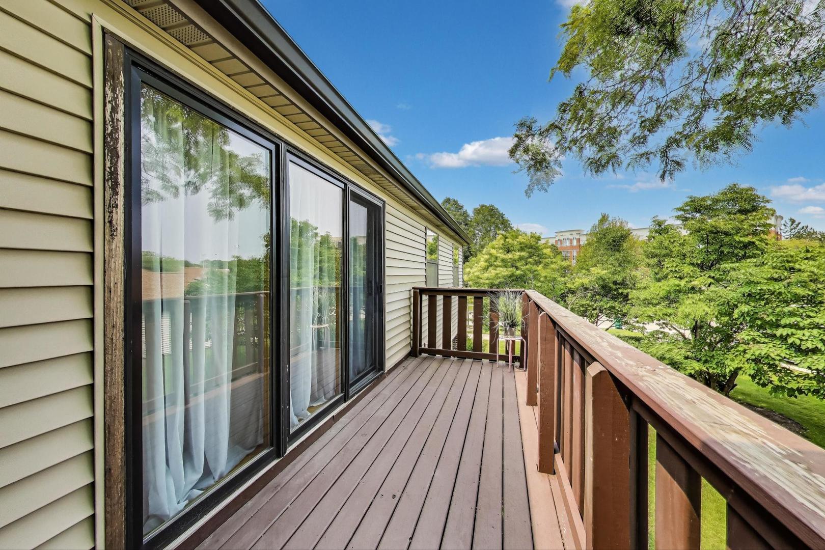 738 Hapsfield Lane, Unit 7A2 Buffalo Grove, IL 60089 - Photo 24 of 29 a balcony with wooden floor outdoor seating