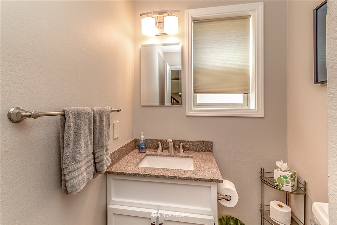 3126 210th Street Southeast Bothell, WA 98021 - Photo 12 of 33 a bathroom with a granite countertop sink and a mirror