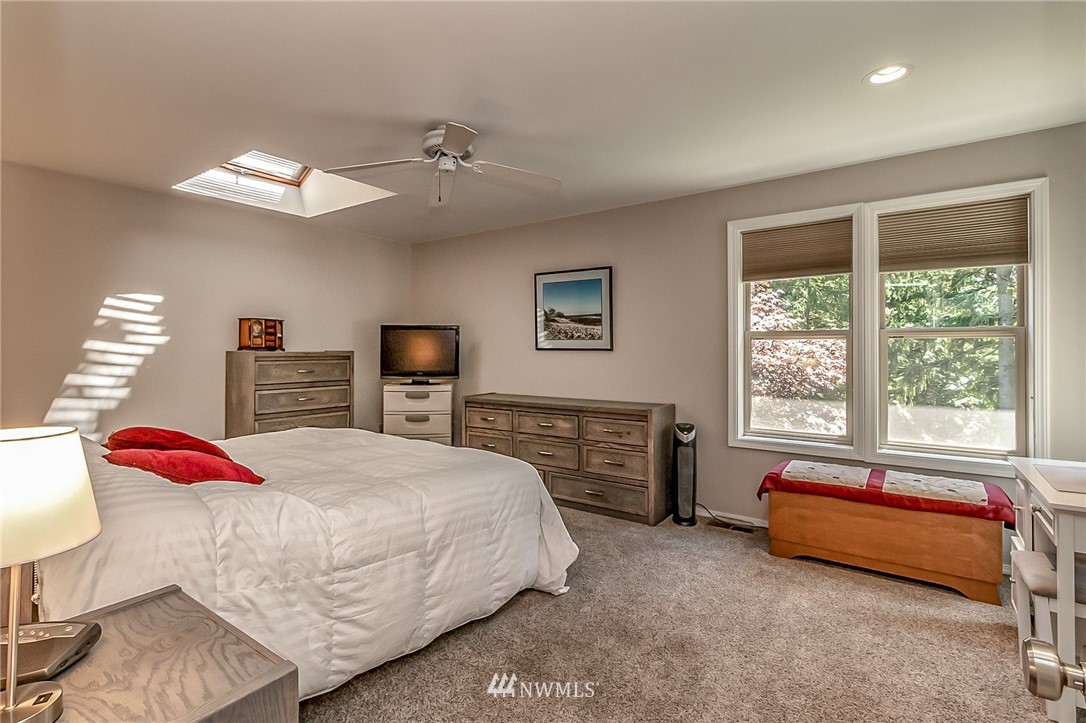 3126 210th Street Southeast Bothell, WA 98021 - Photo 15 of 33 a bedroom with a bed and dresser with chair