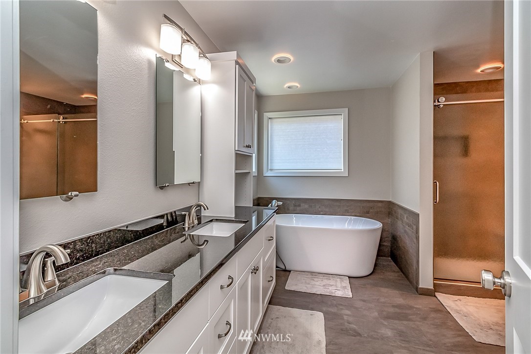3126 210th Street Southeast Bothell, WA 98021 - Photo 18 of 33 a bathroom with a tub sink and mirror