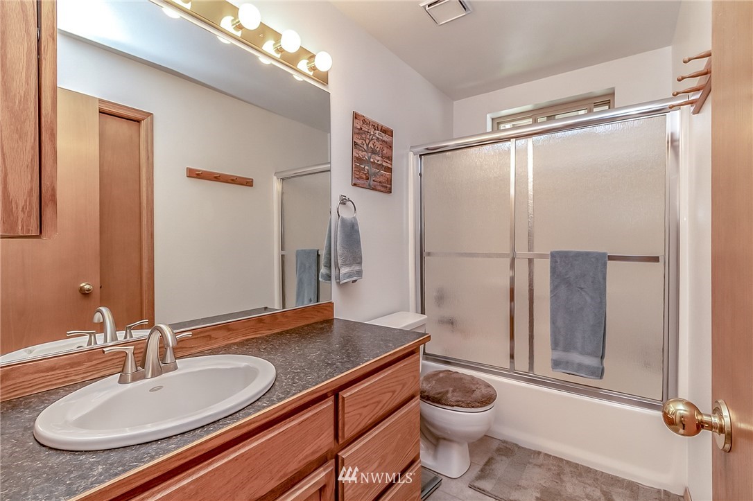 3126 210th Street Southeast Bothell, WA 98021 - Photo 20 of 33 a bathroom with a granite countertop sink toilet and shower