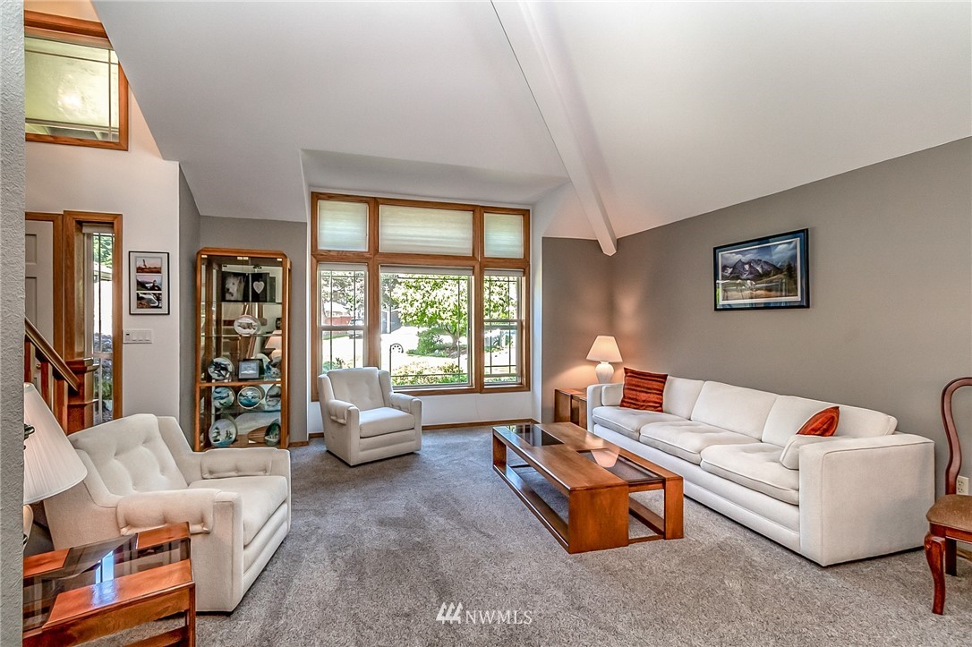 3126 210th Street Southeast Bothell, WA 98021 - Photo 4 of 33 a living room with furniture and a large window
