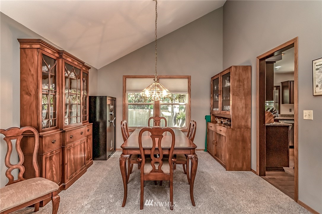 3126 210th Street Southeast Bothell, WA 98021 - Photo 5 of 33 a dining room with furniture a chandelier and window