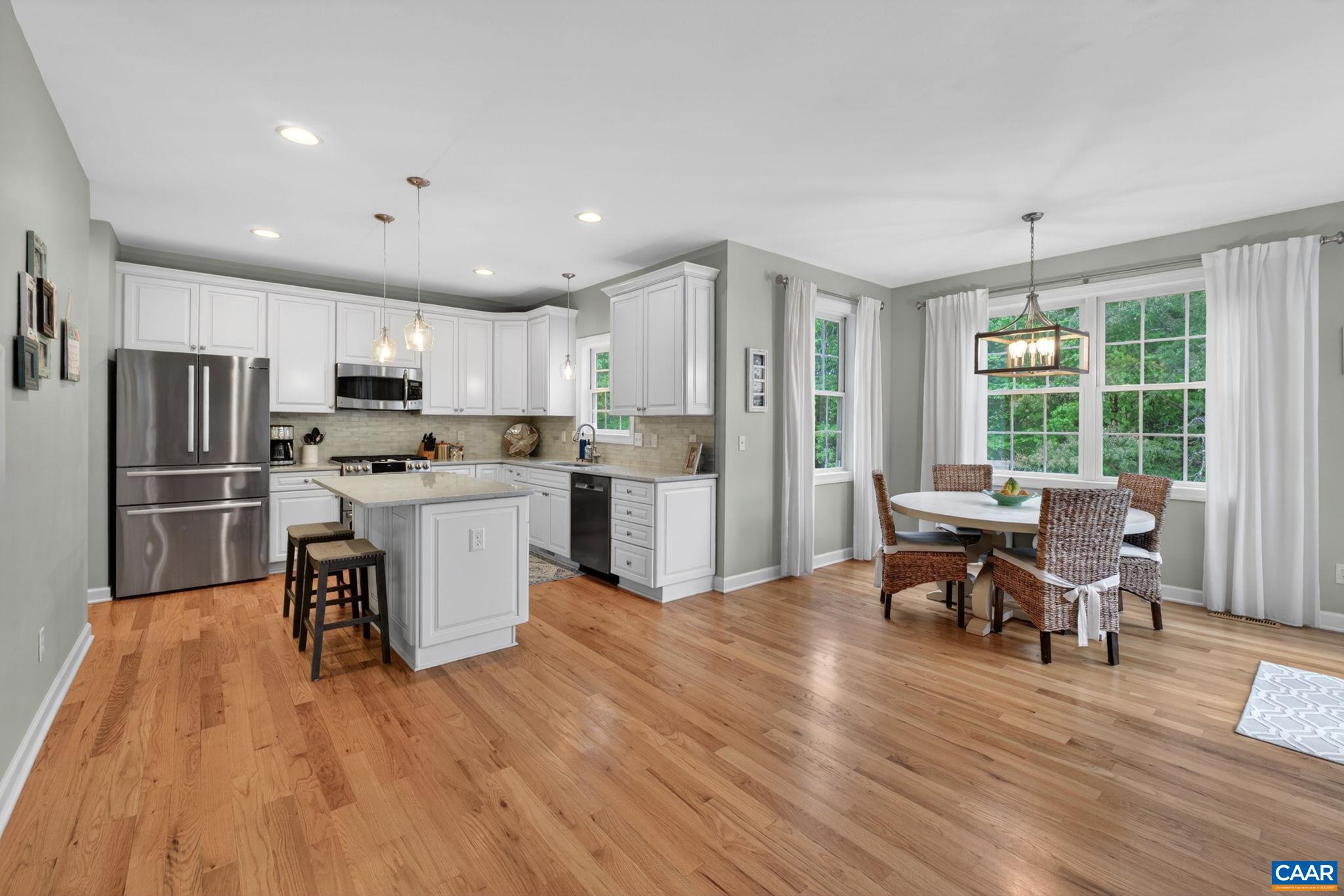 511 Taylor Ridge Way Palmyra, VA 22963 - Photo 17 of 57 a kitchen with a table chairs refrigerator and chairs