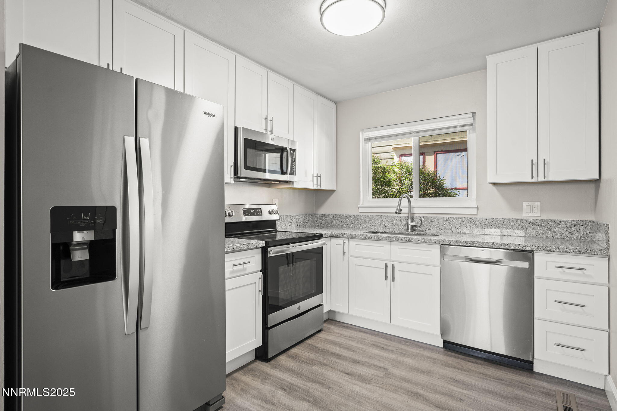 1227 Gordon Avenue Reno, NV 89509 - Photo 10 of 22 a kitchen with stainless steel appliances granite countertop a refrigerator stove and sink