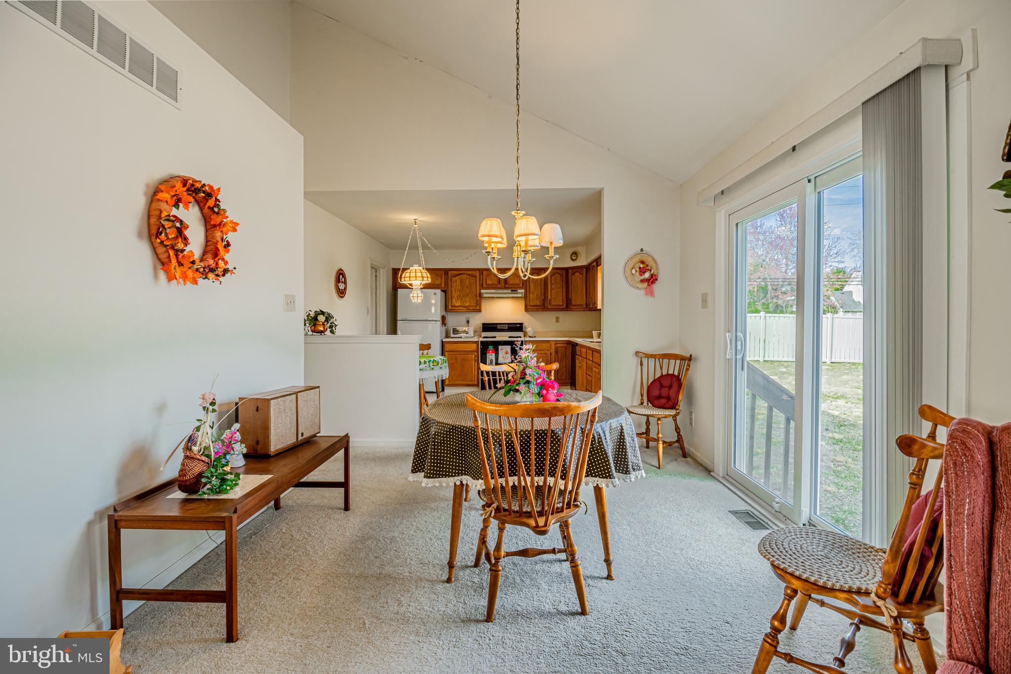 333 Copperfield Drive Williamstown, NJ 08094 - Photo 2 of 17 a dining room with furniture a rug and a chandelier
