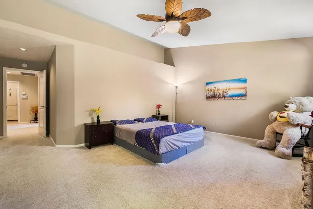 a patio with table and chairs and potted plants