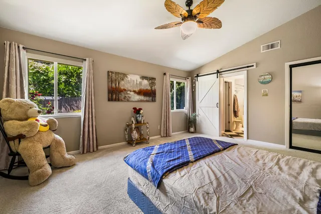 a view of a house with yard and a garden