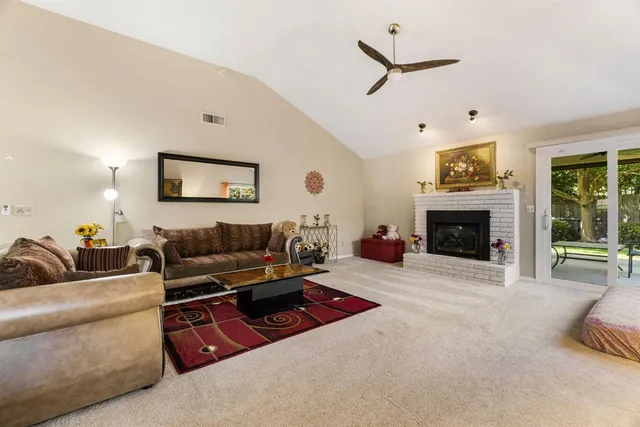a kitchen with kitchen island granite countertop a sink a counter top space appliances and cabinets