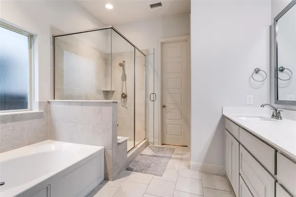 a bathroom with a tub sink and a mirror