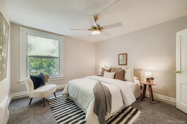 a bedroom with a bed and a couch