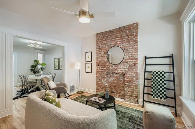 a living room with fireplace furniture and a wooden floor