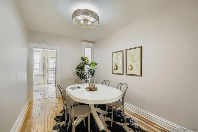 a view of a dining room with furniture and a chandelier