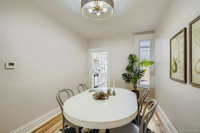 a view of a dining room with furniture and window