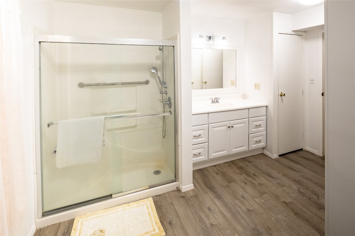 3351 Goforth Road Kyle, TX 78640 - Photo 5 of 8 a bathroom with a double vanity sink a mirror and a shower