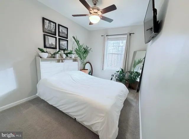 a large bed sitting in a bedroom and a flat tv screen