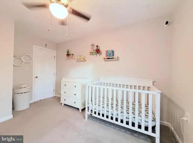a bedroom with a baby bed baby crib and a dresser