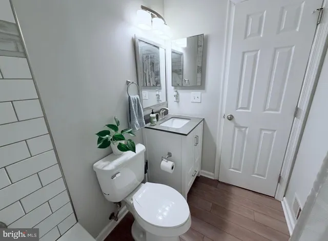 a white toilet sitting next to a bathroom sink