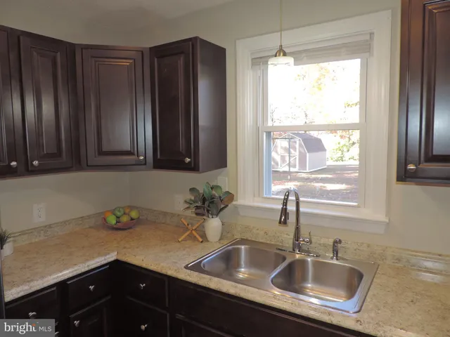a kitchen with a sink cabinets and window