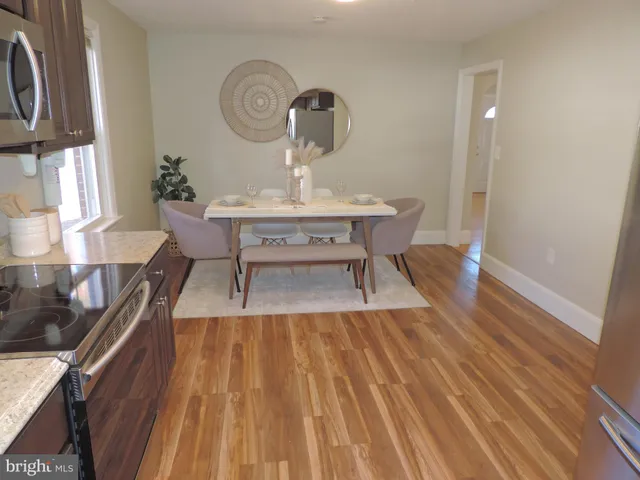a view of a dining room with furniture and wooden floor