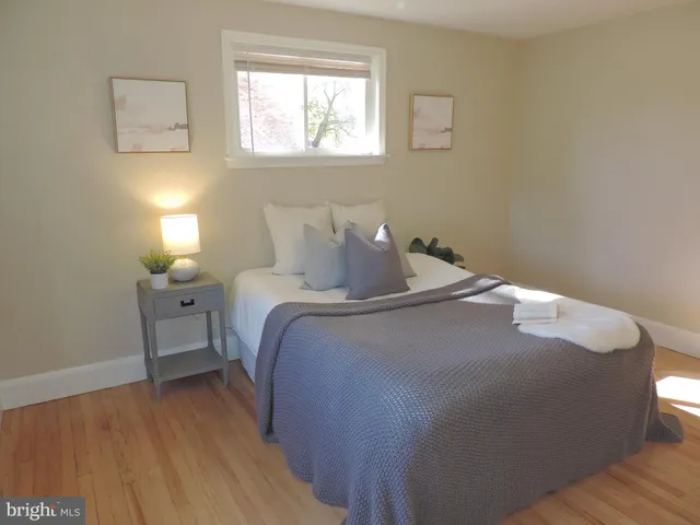 a bedroom with a bed and a lamp