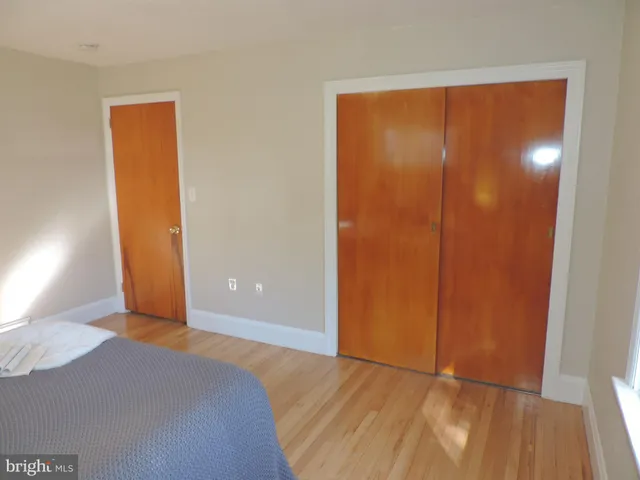 a view of a room with wooden floor and a window
