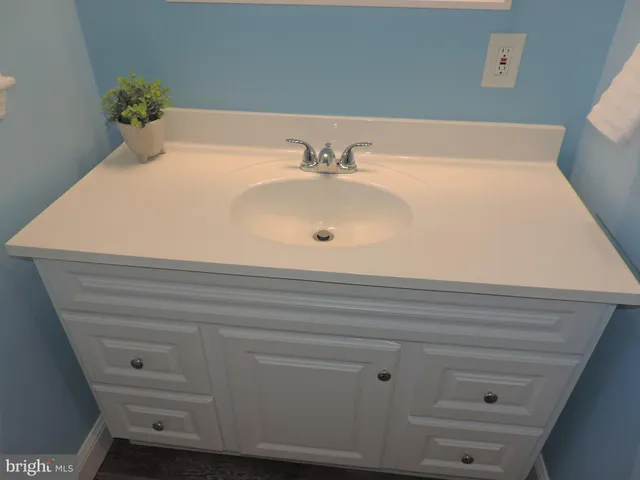 a bathroom with a sink and a window